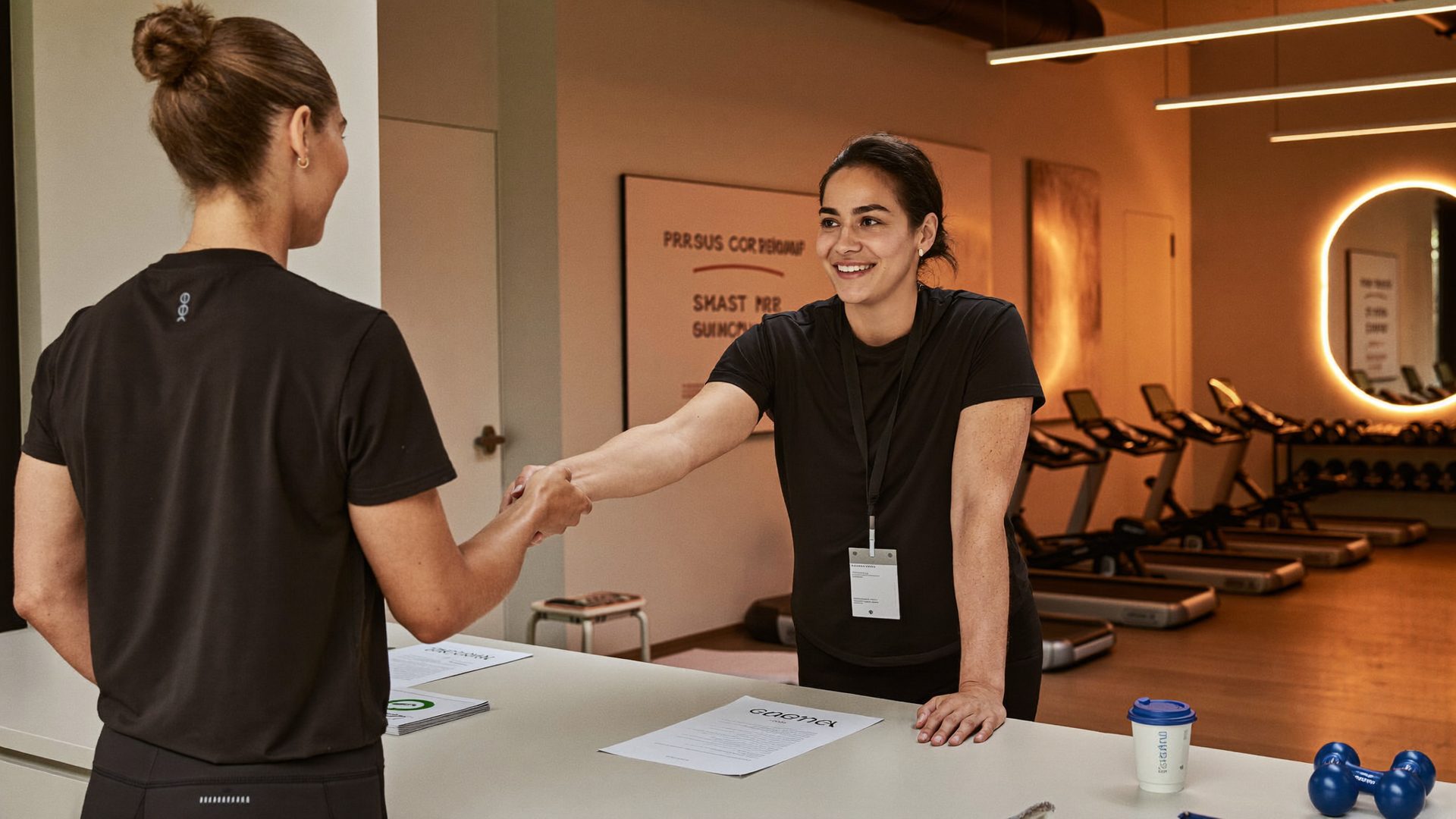 A friendly gym manager at a reception desk